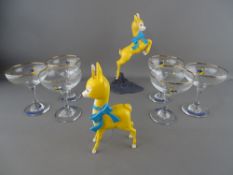 Two Babycham celluloid advertising figurines and a set of six Babycham glasses