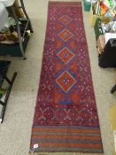 Meshwani carpet runner, red and blue ground, triple bordered with repeating central diamond pattern,