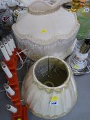 Two large lampshades with beadwork decoration and one other with two decorative table lamps