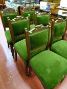 Set of four Edwardian oak upholstered dining chairs with carved detail plus two similar but non-