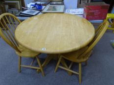Light wood circular topped pedestal dining table and two stickback chairs