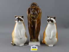 Three Russian porcelain animal figurines - two raccoons and an ape