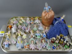 Good collection of porcelain pin cushion dolls and miniature Toby jugs