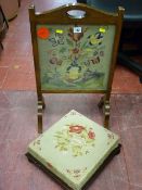 Oak framed needlework firescreen and a tapestry top antique footstool on turned bun feet
