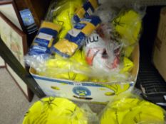 Box of many deflated volley balls, sport socks etc