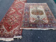 Two modern red ground classically styled carpets