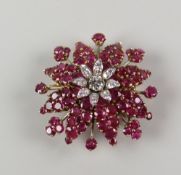 AN 18CT YELLOW & WHITE GOLD DIAMOND & RUBY STAR BURST BROOCH the central diamond surrounded by eight