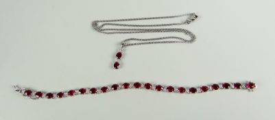 AN 18K WHITE GOLD RUBY & DIAMOND SET BRACELET of alternating flower head diamonds & oval ruby