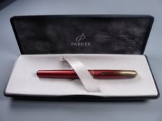 A MODERN (2001-2004) BOXED SUNNY RED PARKER INFLECTION FOUNTAIN PEN with gold plated trim &