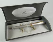 A MODERN STAINLESS STEEL PARKER SONNET FOUNTAIN PEN with gold trim (in original box)