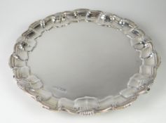 SMALL SILVER PIE CRUST & SHELL DESIGN EDGE SALVER raised on three scroll design feet, Sheffield