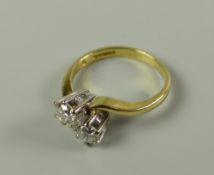 AN 18CT GOLD TWO-STONE DIAMOND TWIST SHANK CROSSOVER RING each diamond approx. .15cts (.3cts