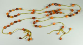 VINTAGE AMBER TASSEL NECKLACE consisting of oval amber beads of various colour, terminating in