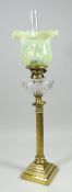 AN ANTIQUE BRASS OIL LAMP with twist-style column on a stepped base, cut-glass reservoir &