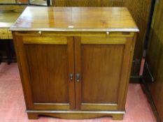 A VINTAGE MAHOGANY TWO DOOR CABINET with top brushing slide, 92 cms high, 92 cms wide, 48.5 cms