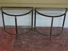 A PAIR OF MID 20th CENTURY BRASS SEMI-CIRCULAR OCCASIONAL TABLES with glass inset tops, 44 cms high,