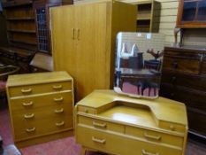 A VINTAGE G-PLAN LIGHT OAK THREE PIECE BEDROOM SUITE of two door wardrobe, mirrored dressing table