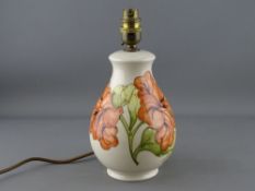 A MOORCROFT 'HIBISCUS' TABLE LAMP, cream ground, 26 cms high overall (crazing)