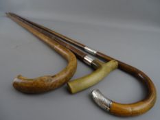 THREE VINTAGE WALKING STICKS, two having hallmarked silver mounts, 93 cms the longest