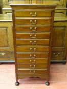 AN EDWARDIAN MAHOGANY MUSIC SHEET CABINET of ten drawers on turned bun feet 118.5 cms high, 53.5 cms