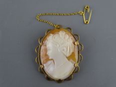 A TWELVE CARAT GOLD MOUNTED CAMEO BROOCH