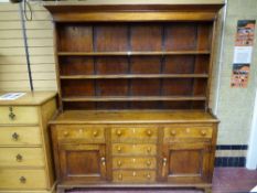 A GEORGE III WELSH OAK DRESSER, the wide boarded rack over a 'T' arrangement of six opening