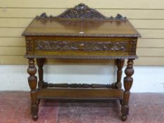 A CARVED OAK SINGLE DRAWER HALL TABLE with rail back and egg and dart moulding, on reeded block