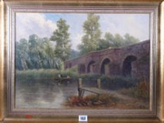 THOMAS M ASH oil on canvas laid on board - Welsh river scene with bridge and figures, signed in full