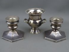 A PAIR OF SILVER SQUAT CANDLESTICKS and a small campana style silver vase, Birmingham 1963 and