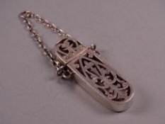 A LADY'S SILVER POMADE HOLDER with chain, the body of pierced and scrolled decoration, Birmingham