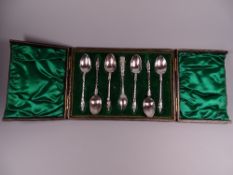 A CASED SET OF SIX SILVER APOSTLE COFFEE SPOONS & SUGAR TONGS, all with twist handles, 4.2 troy ozs,