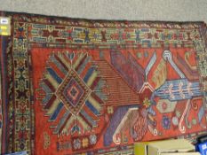 Baluchi pictorial rug, multi-coloured with stylized central pattern on a red ground, 137 x 85 cms