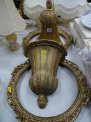 Pair of acorn shaped wall brackets and a pair of oval gilt frames