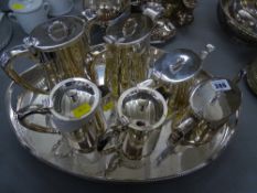 Six hotel type tea and coffee pots on an oval two handled tray