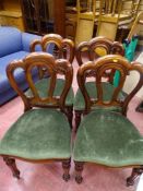 Set of four balloon back dining chairs with tapered front legs and green upholstery
