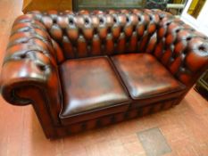 Two seater red leather Chesterfield settee