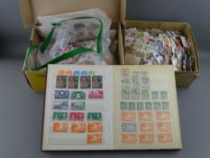 Small album and two boxes of unsorted postage stamps