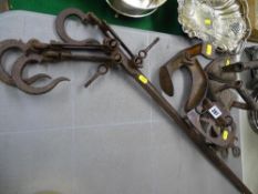 Vintage iron work including a beaten meat hook, two flat irons and trivet stands etc