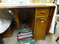 Mid Century polished wood drop leaf dining table with end cupboard and drawer