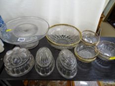 Vintage glass comport, three glass jelly moulds and a gilt decorated fruit set