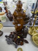 Treen items to include a carved monk figurine, a quantity of modern lovespoons etc