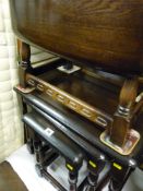 Dark polished wood Priory style nest of three tables and a similar drop leaf table