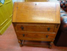 Oak two drawer writing bureau with interior sliding compartment