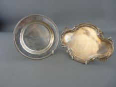 Hallmarked silver circular dish and a white metal shaped tray with decorative edge