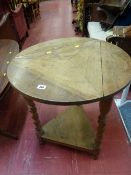 Oak cricket table on barley twist supports and swivel triple flap top