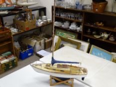Model yacht on stand with blue painted keel, 72 cms long (no sails)