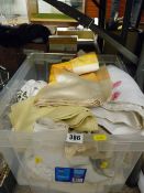 Plastic crate of vintage linen