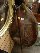 Painted African hide shield and a lion's head carved walking cane