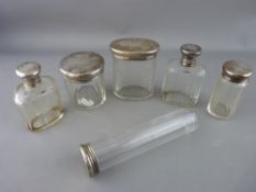 Six silver topped dressing table bottles (monogrammed)