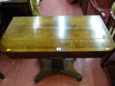 Antique rosewood foldover card table with baize lined interior on a beaded column stem and